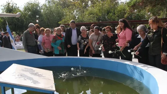 Homenaje con flores blancas de las familias a los héroes