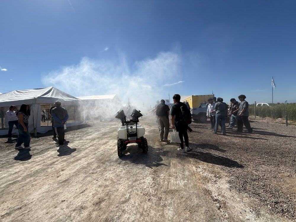 La nube de pulverización del robot XAG R200 se eleva sobre el predio, ante la mirada de los visitantes.