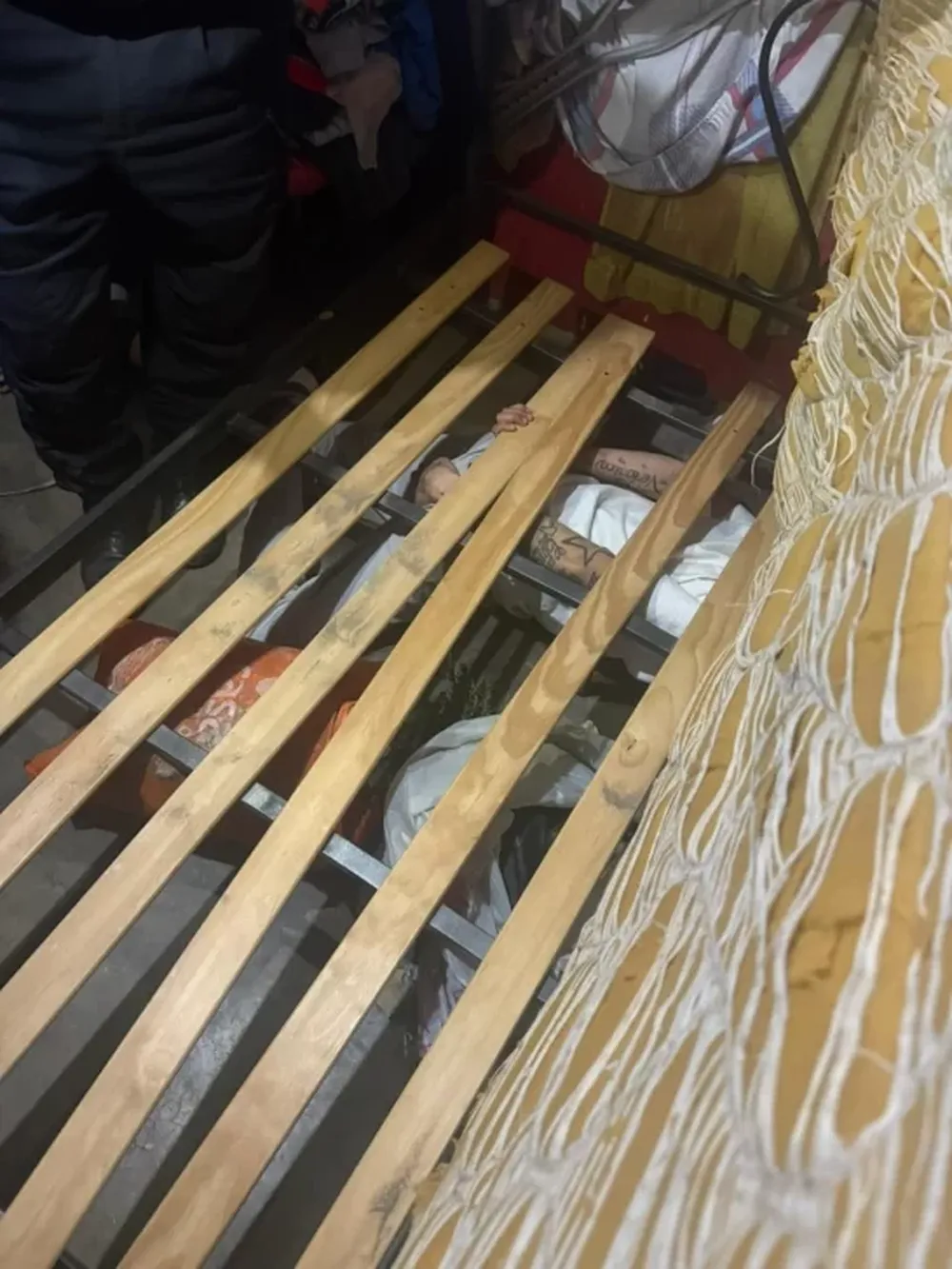 Abajo de la cama. Allí se escondió uno de los detenidos.
