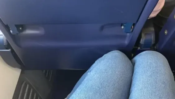 Se quedó por poco espacio entre los asientos del avión y recibió una polémica respuesta