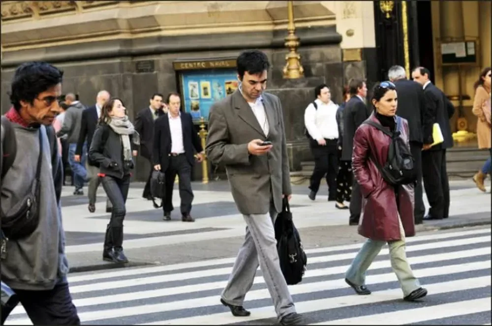 Buscan sancionar a peatones que crucen la calle hablando por celular